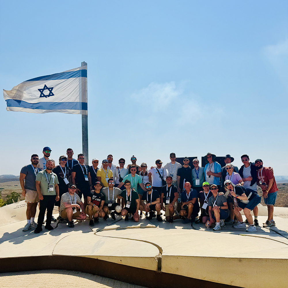 Group of people standing together and smiling at a community gathering