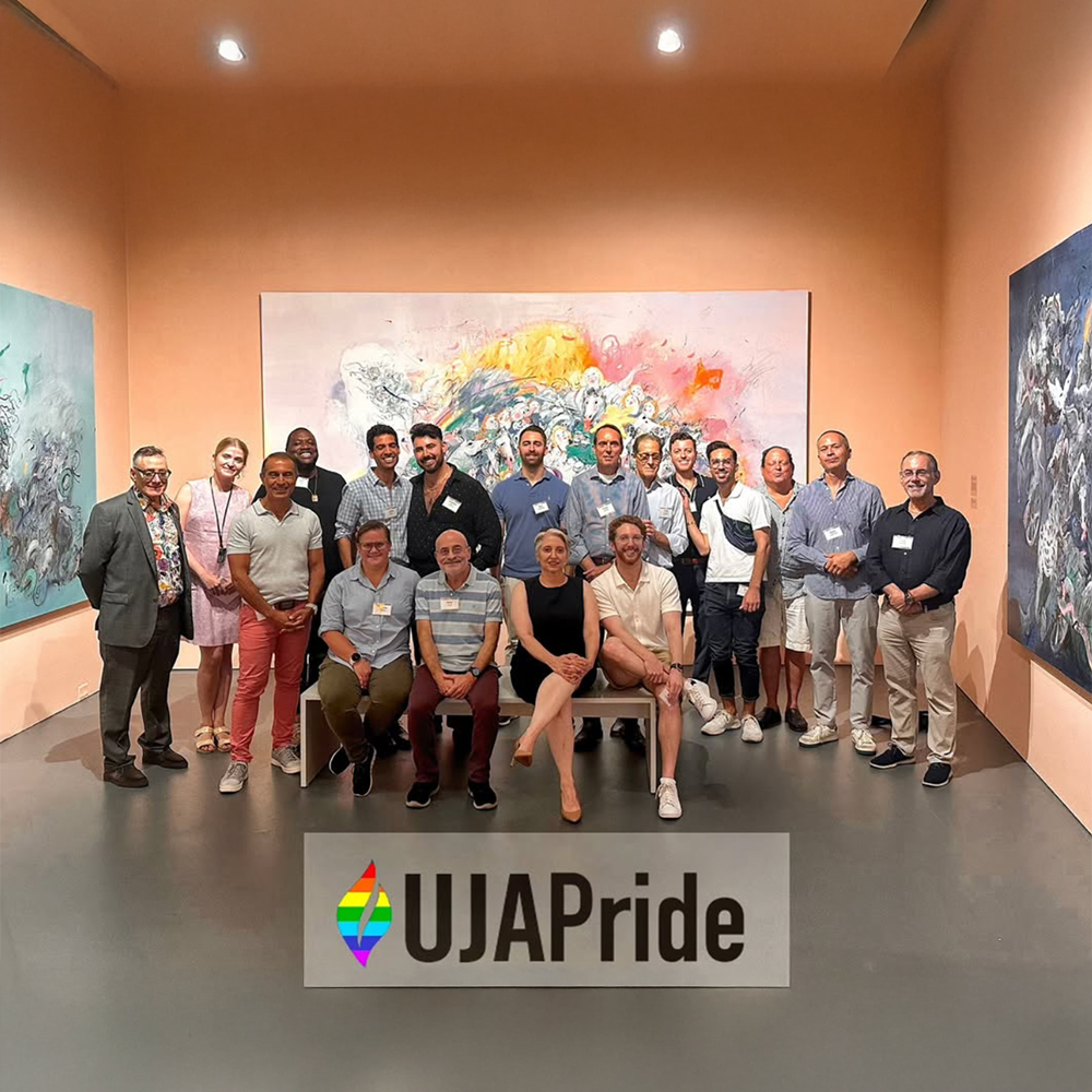 Group of people posing together in a gallery setting
