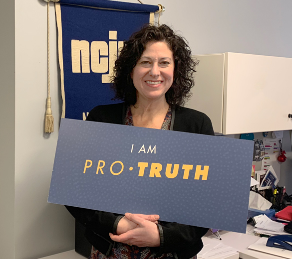 UJA Federation of New York >> Andrea Kopel, executive director of the National Council of Jewish Women New York (NCJW NY), shows sign used to promote the Pro Truth Campaign, a coalition to protect women's health led by NCJW NY, with UJA support.