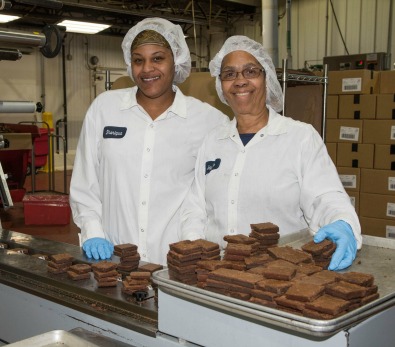 UJA Federation of New York >> Employees at Greyston Bakery, with some of the 35,000 brownies the bakery produces each day.