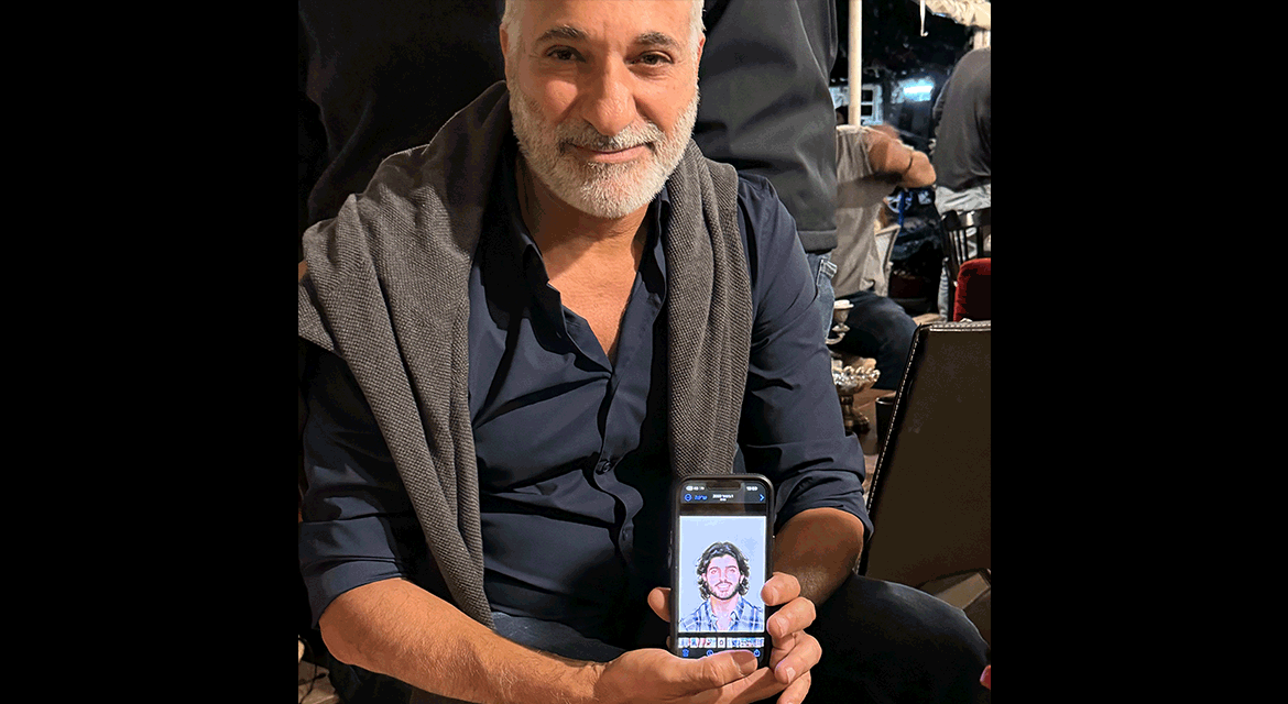 UJA Federation of New York >> <center>
<p><em>Menashe, Omri's father, holds up a picture of his son.</em></p>
</center>